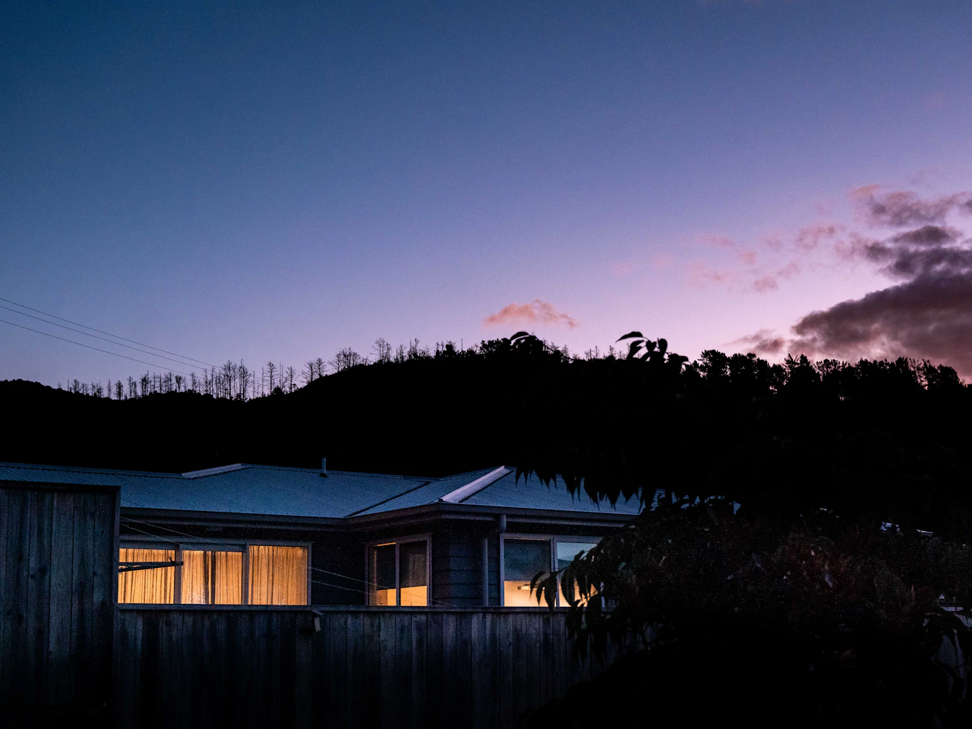 A house with lit windows at dusk